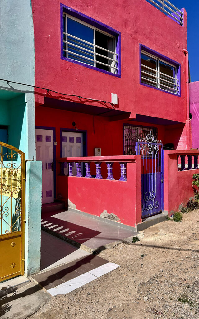 Aghroud village featuring vibrant rainbow-colored houses along the Atlantic coast in Morocco.