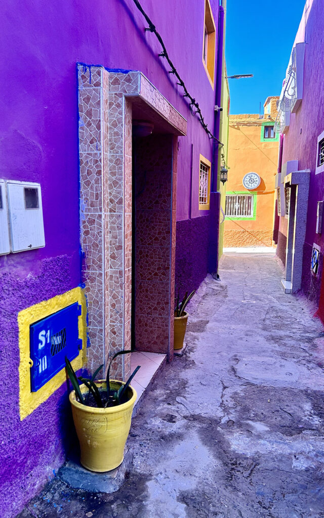Aghroud village featuring vibrant rainbow-colored houses along the Atlantic coast in Morocco.