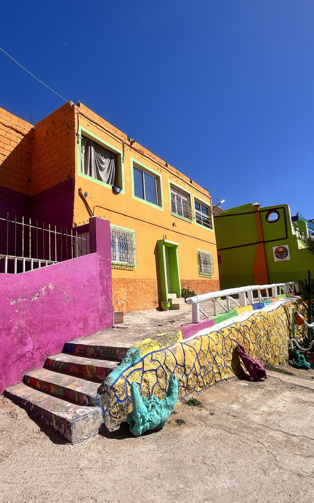 Aghroud's unique colorful architecture and coastal scenery on a sunny day in Morocco.