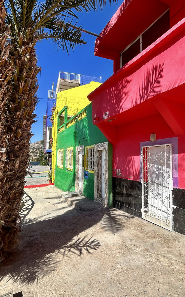 Aghroud village featuring vibrant rainbow-colored houses along the Atlantic coast in Morocco.