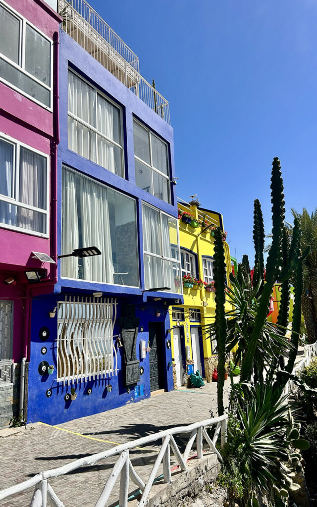 Traditional Moroccan architecture painted in bright colors overlooking the ocean in Aghroud.