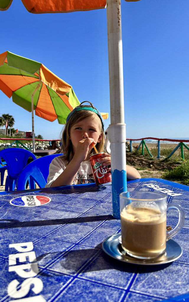 Traditional Moroccan architecture painted in bright colors overlooking the ocean in Aghroud.