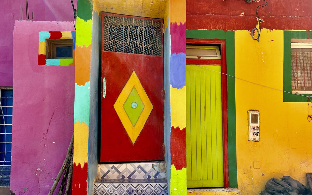 Aghroud village featuring vibrant rainbow-colored houses along the Atlantic coast in Morocco.