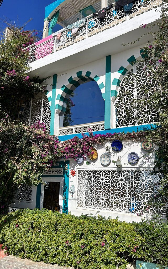 Traditional Moroccan architecture painted in bright colors overlooking the ocean in Aghroud.