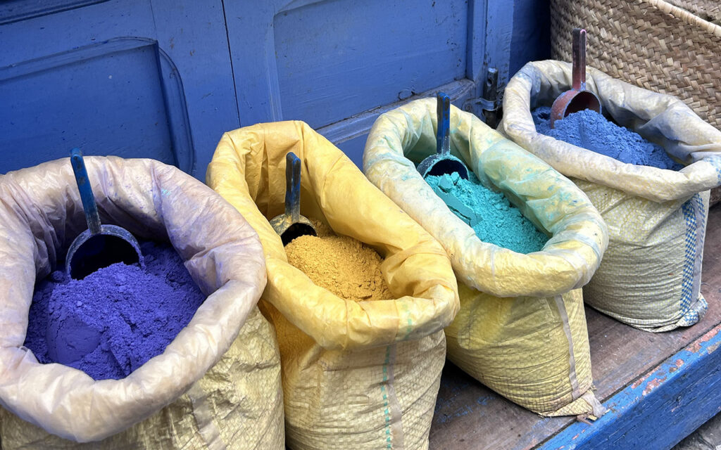 Traditional colorful powder dyes and blue pigments sold in wooden sacks in Chefchaouen, the famous Blue City of Morocco
