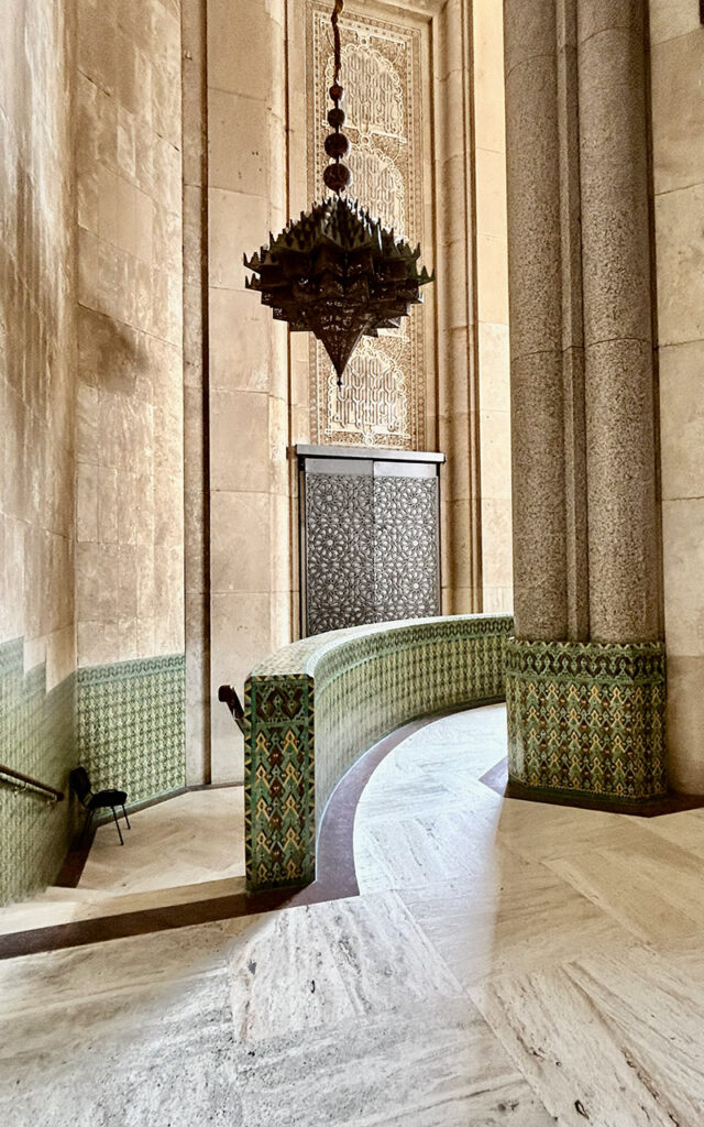 Ablution hall inside Hassan II Mosque in Casablanca with green Moroccan tiles, curved architecture and soft natural light