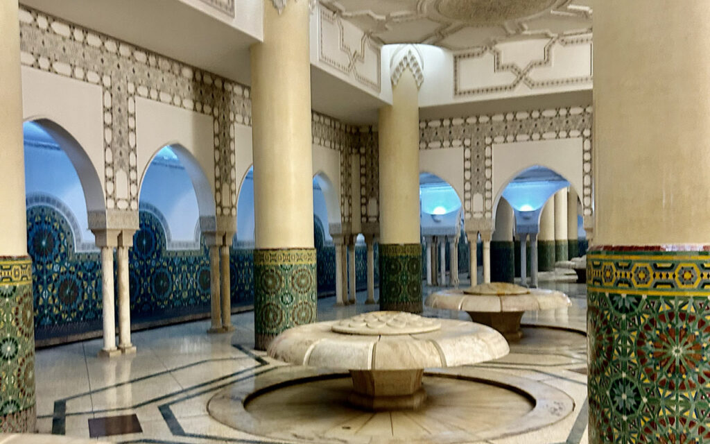 Ablution hall inside Hassan II Mosque in Casablanca with columns, fountains and colorful Moroccan tiles
