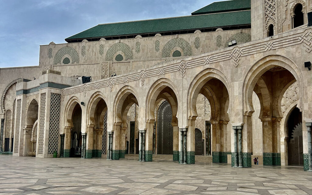 Arched facade of Hassan II Mosque in Casablanca with detailed stonework