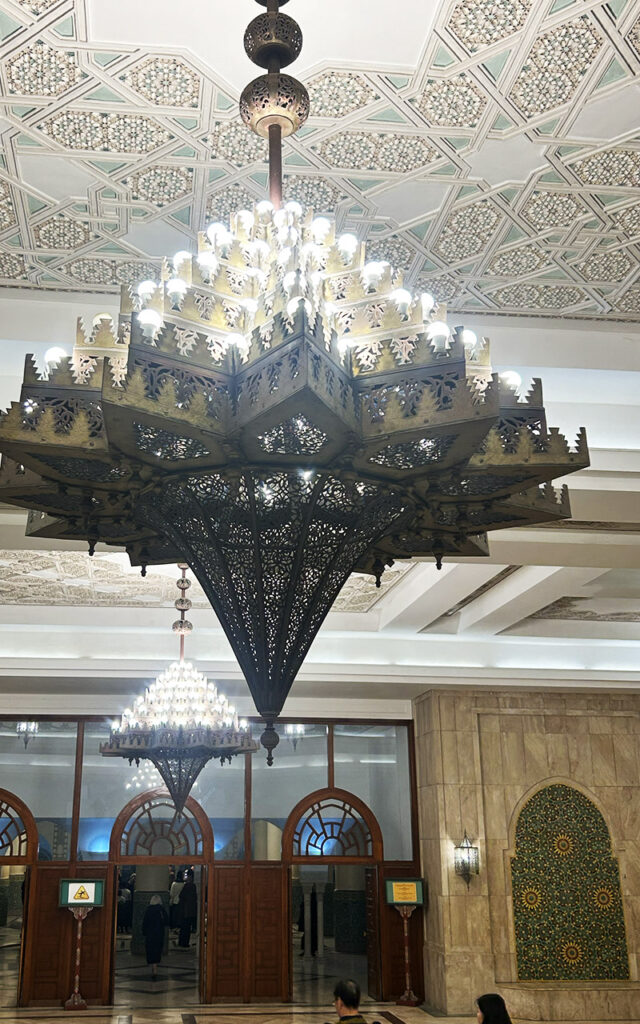 Large ornate chandelier and detailed ceiling inside Hassan II Mosque in Casablanca Morocco