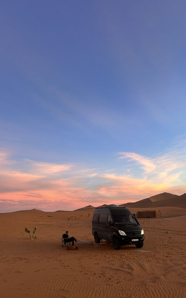 Off-grid vanlife in Morocco with MO THE BLACK, a custom self-built 4x4 Mercedes Sprinter parked in a dessert sunset – Morocco Notes.