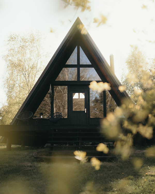 Two stylish black A-frame cabins for a cozy nature getaway
